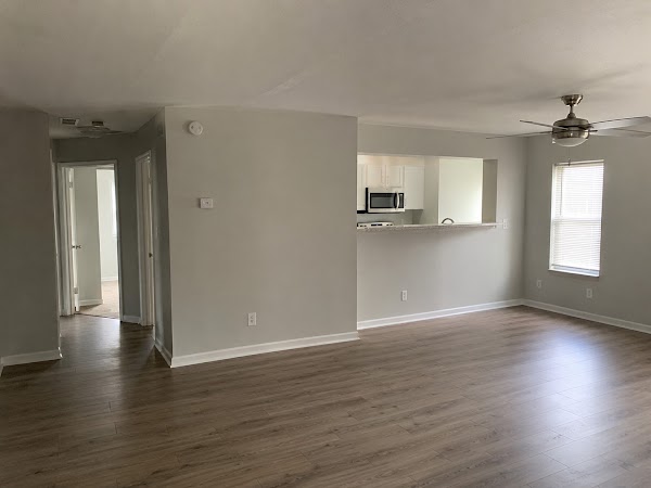 Clean and empty living area with polished floors after a move-out clean