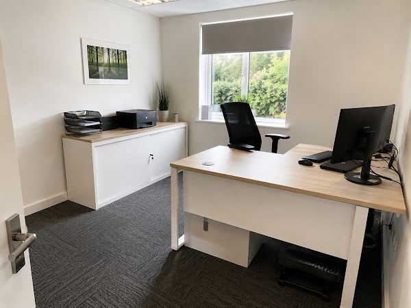 Tidy private office with clean desk, chair and carpet